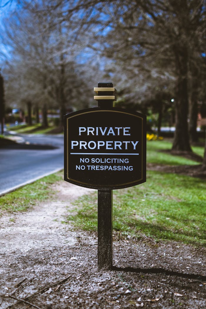 Mastering the First Impression: Your intriguing post title goes here Black sign displaying Private Property warning with trees in the background.
