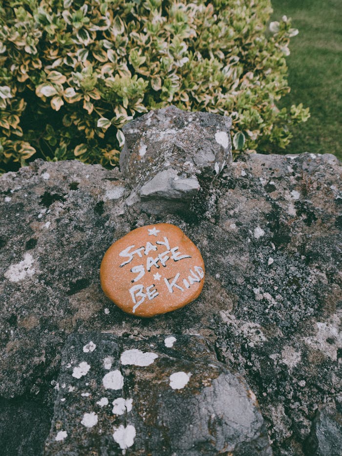 The Art of Drawing Readers In: Your attractive post title goes here Stay Safe Be Kind text carved on stone in green park during coronavirus pandemic